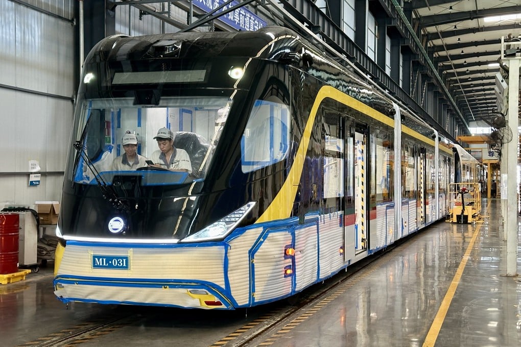 Workers are seen inside a carriage of an autonomous rapid transit vehicle at a CRRC plant in Yibin, southwest China’s Sichuan province. When construction is complete, the bus will be shipped to Kuching, Malaysia. Photo: Frank Chen