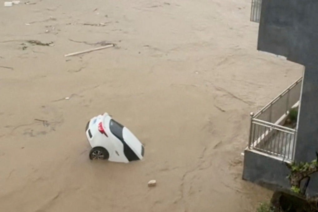A screen grab from a social media video shows a partially submerged car being carried away by floodwaters after Typhoon Noul brought torrential rain to Puning, Guangdong province, late last month. Photo: Reuters