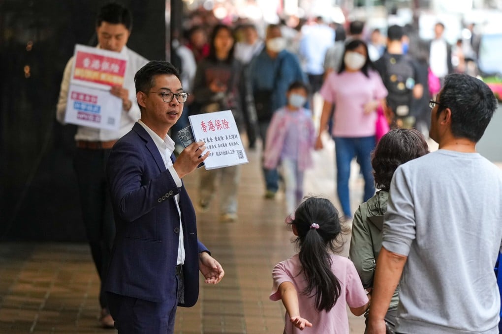 Insurance sales agents approach mainland tourists on Canton Road in Tsim Sha Tsui, Hong Kong. Photo: Eugene Lee