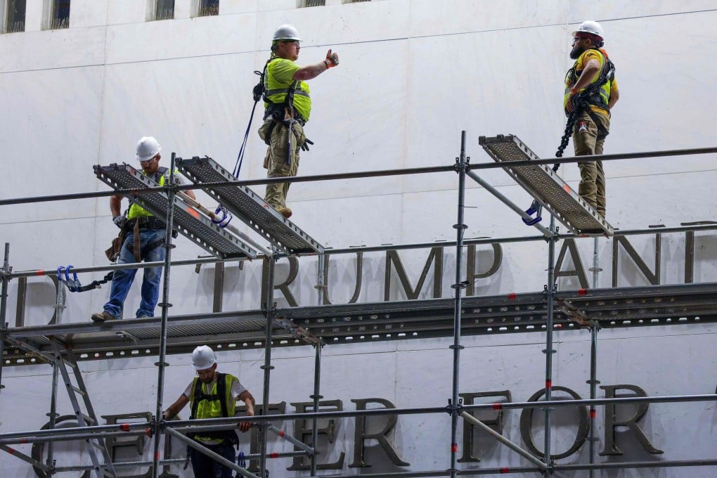 Construction crews build scaffolding outside The Kennedy Centre in June, after a court ordered that Trump’s name be removed from the building. Photo: AFP