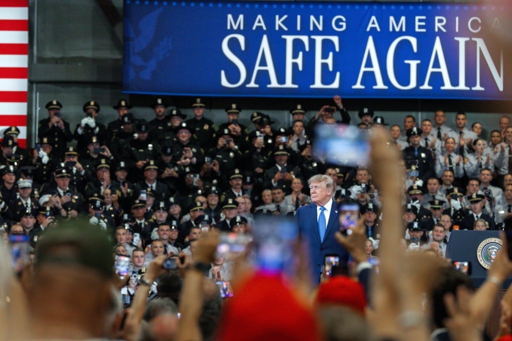 Supporters cheer as US President Donald Trump arrives to make a speech in Garden City, Nassau County, on Long Island, New York, on Friday. Photo: EPA