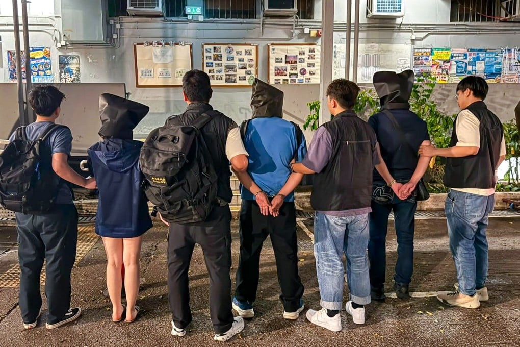 Police escort suspects arrested as part of a crackdown on a phone scam syndicate. Photo: Handout