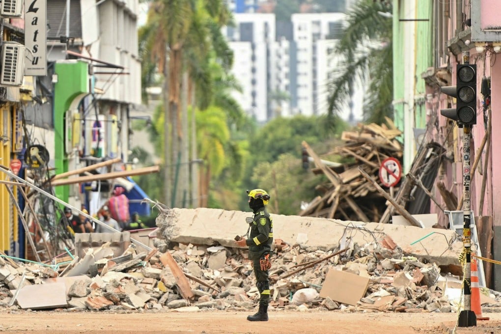 A rescuer stands in a street full of debris in Pereira, Colombia, on Saturday. Photo: AFP