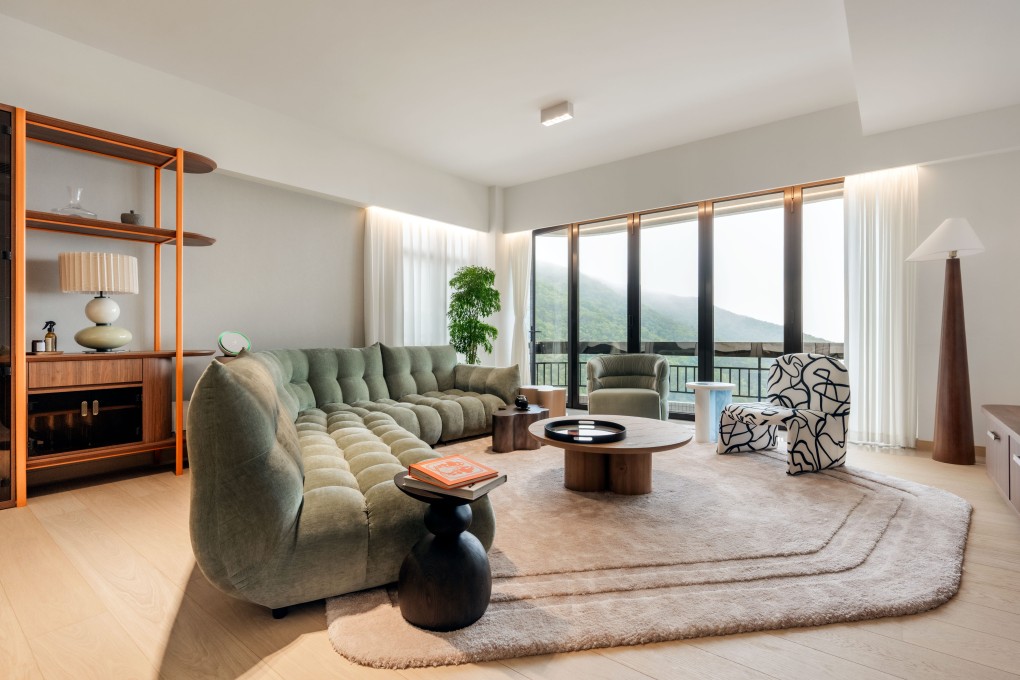 The large living area of this Repulse Bay apartment was sectioned into two zones: one anchored by the sofa for convivial relaxation, the other for dining, connected by a custom-made shelving unit running the length of the side wall. Photo: Eugene Chan