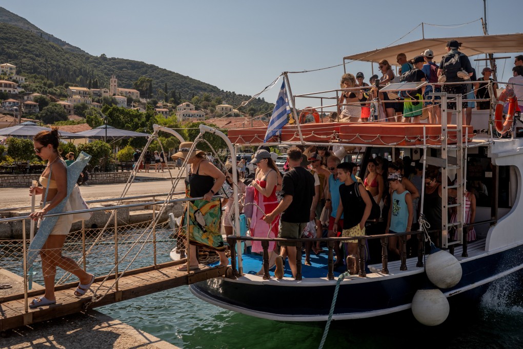 Tourists disembark from a boat after returning from nearby beaches on the island of Ithaca on August 3, 2026. Ithaca is widely believed to be the home of the hero Odysseus in Homer’s Odyssey. Photo: AFP