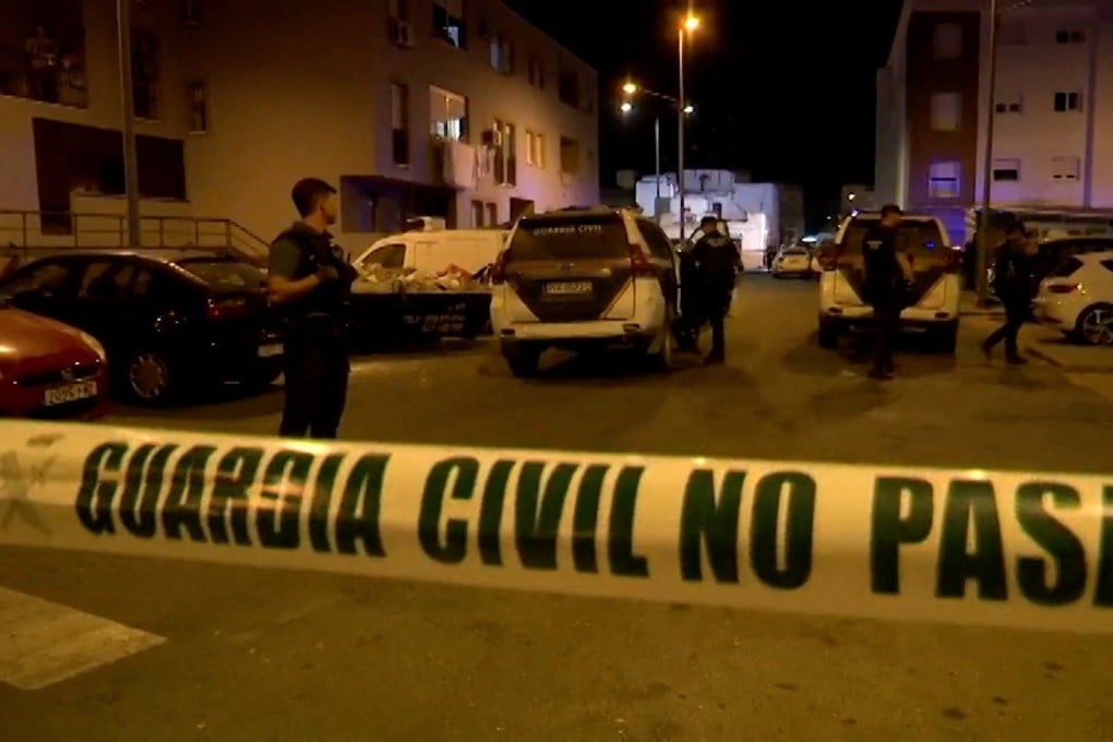 Police officers work at the crime scene where a suspected gang leader’s mother-in-law, his pregnant sister and a teenager were killed in a drug-related shooting in Isla Cristina, Spain on Sunday. Photo: Handout via Reuters