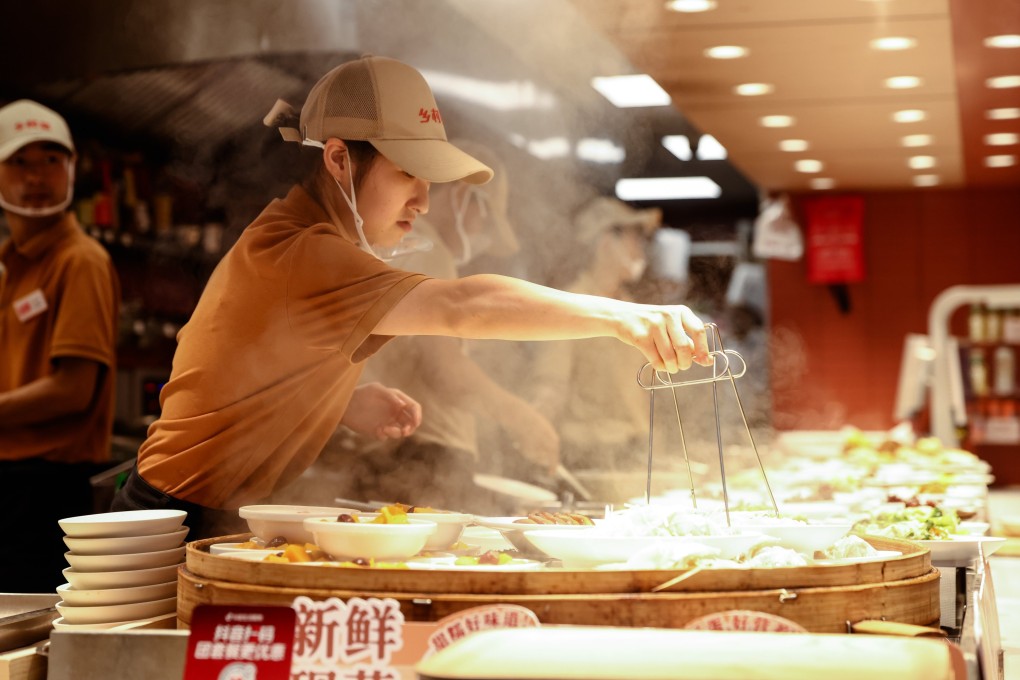 Employees work in a restaurant in Beijing. Photo: EPA