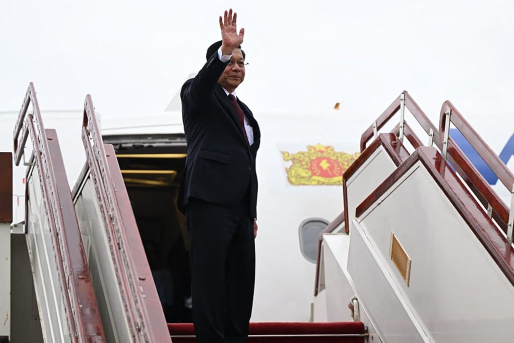 Myanmar’s President Min Aung Hlaing waves as he boards a plane bound for Russia on Monday. Photo: Myanmar’s Presidential Press and Information Bureau / AFP