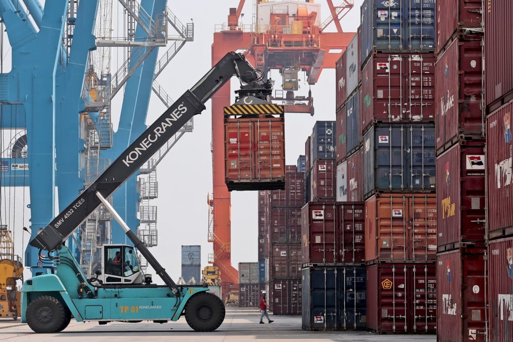 A container lifter is used to organise goods containers at a port in Jakarta, Indonesia. Photo: AP