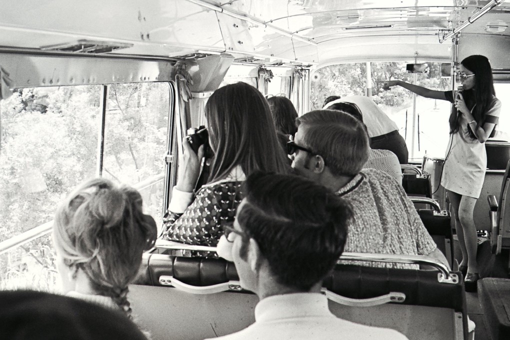 Louisa Lam (standing), one of the city’s 700 registered tour guides, introduces Hong Kong’s many attractions on a sightseeing bus, in 1973. Photo: SCMP Archives