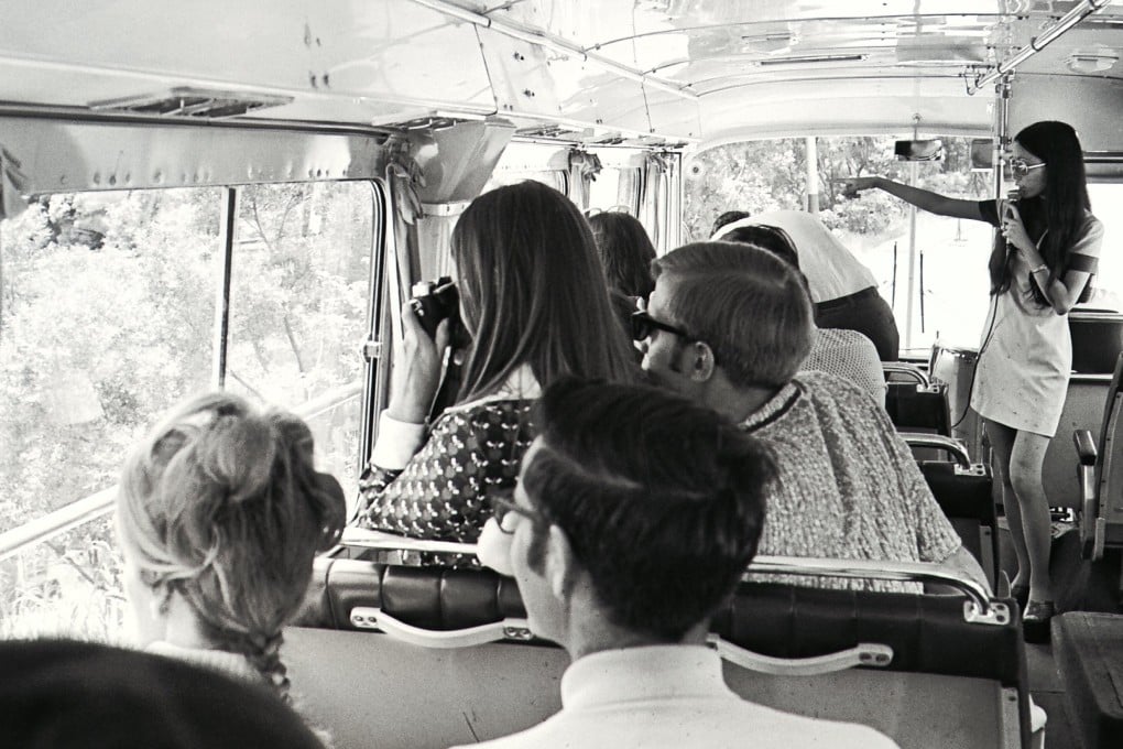 Louisa Lam (standing), one of the city’s 700 registered tour guides, introduces Hong Kong’s many attractions on a sightseeing bus, in 1973. Photo: SCMP Archives