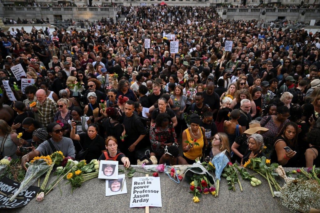 People lay flowers at the end of a vigil by Stand Up To Racism to remember former Cambridge professor Jason Arday, who died aged 41 on Friday after resigning amid plagirism allegations, at Trafalgar Square in London on Monday. Photo: Reuters