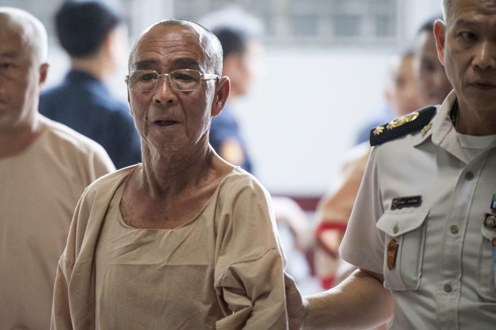 Laota Seanlee (centre) is escorted into a criminal court in Bangkok on December 13, 2017. Photo: AFP
