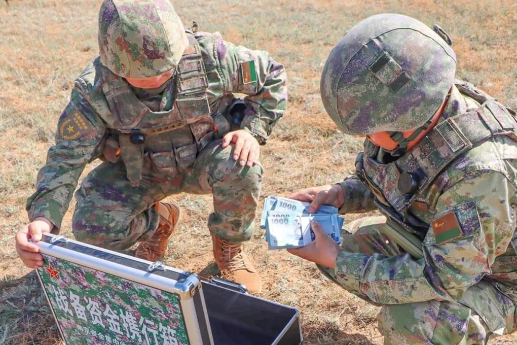 A state newspaper report that has since been deleted included photos of PLA troops counting bundles of New Taiwan dollars delivered by drone during a drill. Photo: qq.com