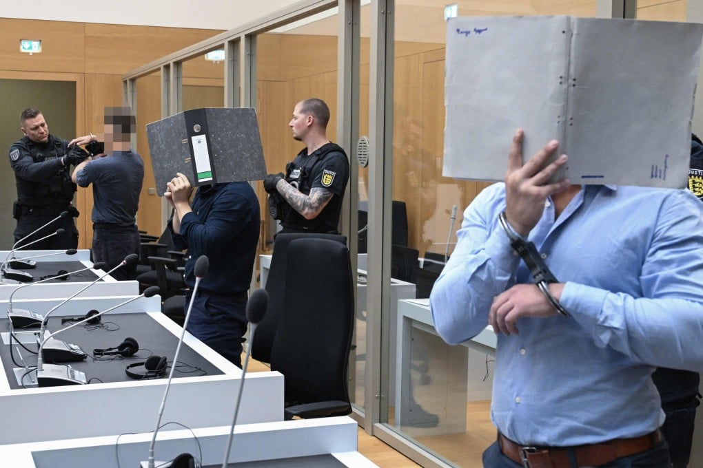Three Ukrainian defendants who are accused for plotting to send exploding parcels from Germany to Ukraine on the orders of a Russian intelligence service, wait for the verdict of their trial in the courtroom of the higher regional court in Stuttgart-Stammheim, southern Germany, on Tuesday. Photo: AFP