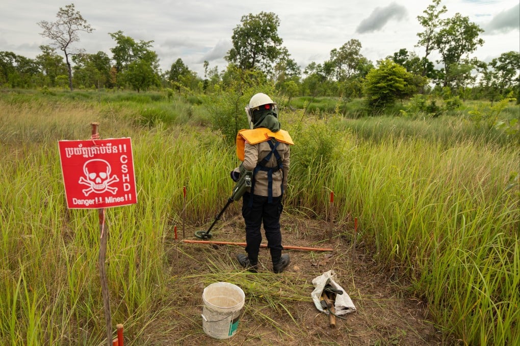 A deminer uses a metal detector to clear a landmine field in Siem Reap, Cambodia, in July. Photo: AP