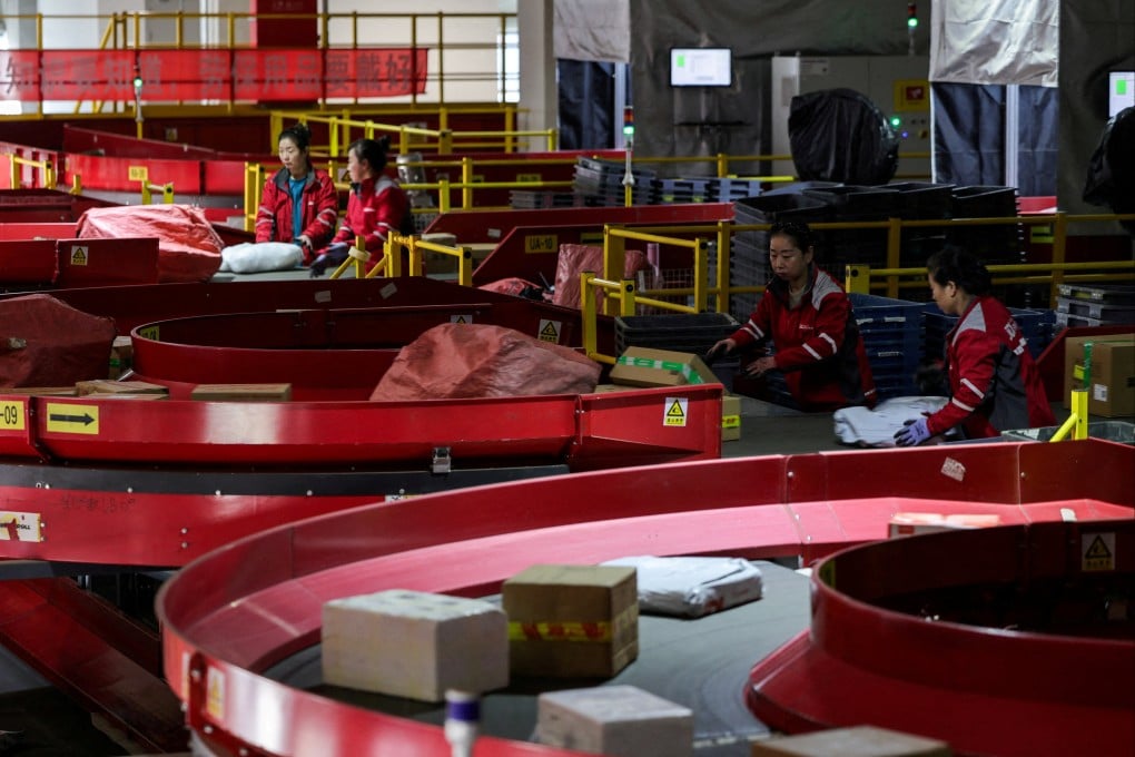 Parcels move along conveyor belts at e-commerce giant JD.com's sorting centre in Beijing. Photo: Reuters