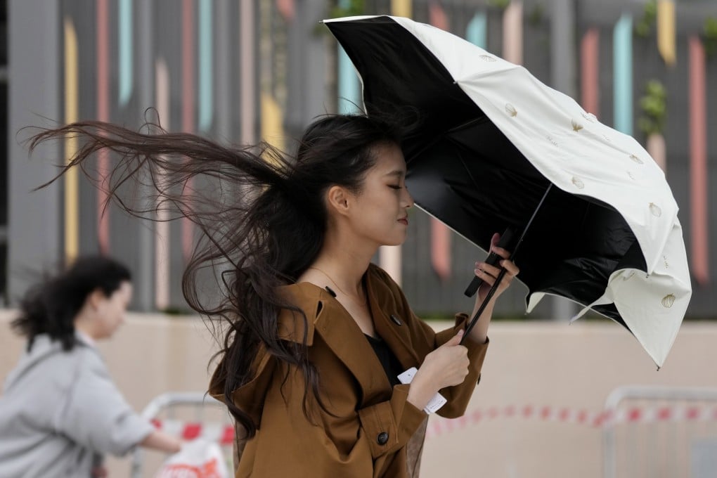 A woman braves strong winds earlier this year. Hong Kong could be set for stormy weather over the weekend. Photo: Karma Lo