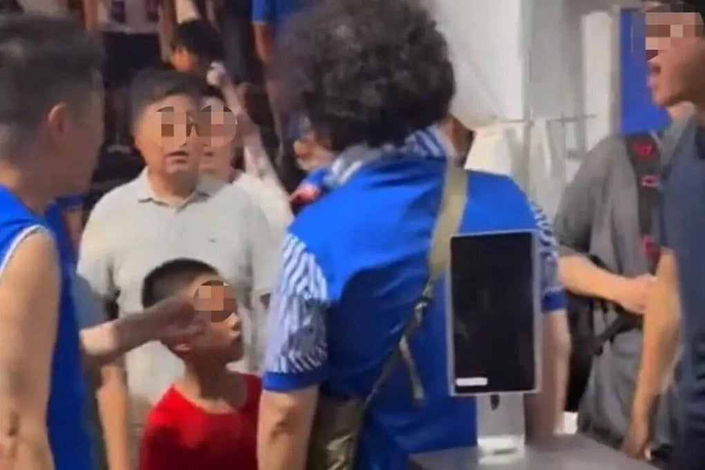 Video footage showed hostile fans pointing and shouting insults at the boy and his father, including asking if the child was “out of his mind”. Photo: Screenshot of video