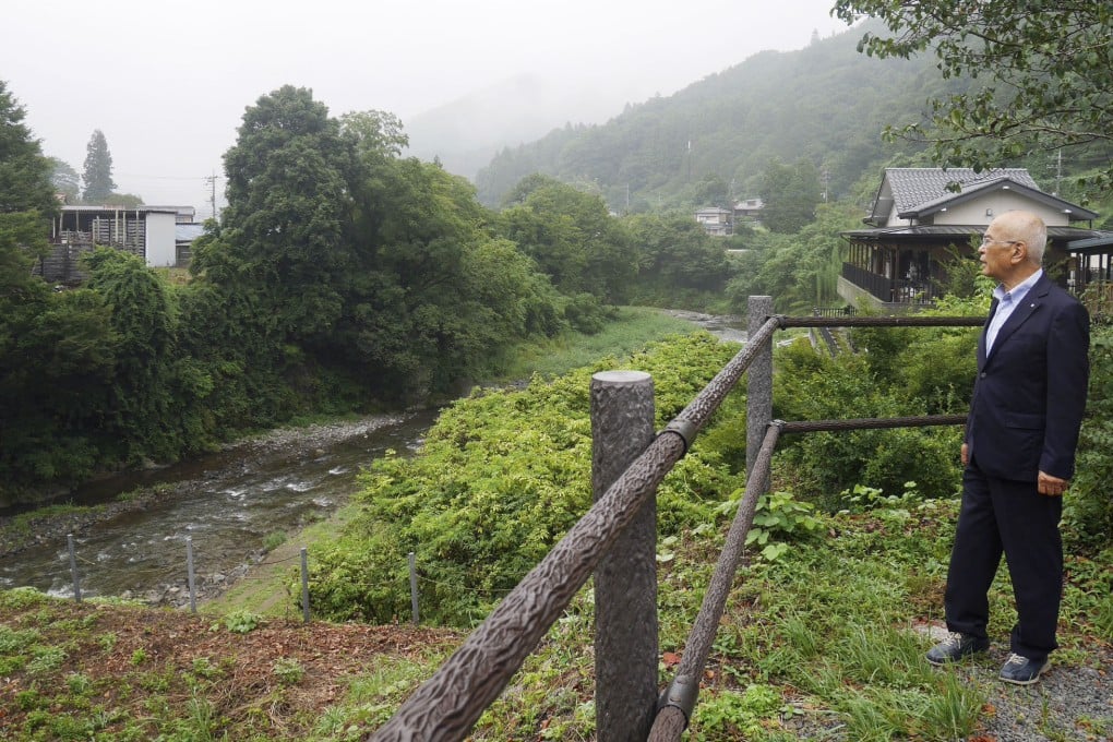 Saijo Hasegawa, mayor of Nanmoku, looks at a river near a roadside station in the Gunma prefecture village on August 3. Photo: Kyodo