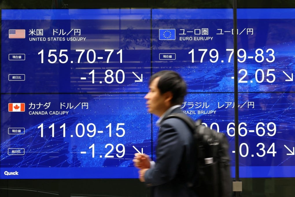 A man walks past an electronic screen displaying the current Japanese yen exchange rate on August 3, after a rare joint US-Japan intervention to prop up the currency. Photo: Reuters