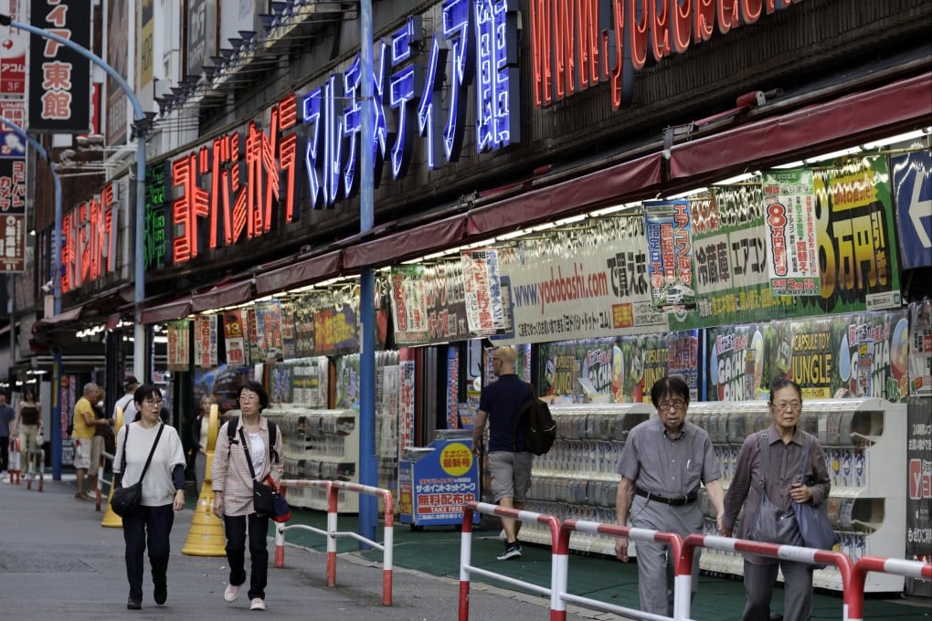 People walk past an electronics retail store in the Shinjuku district in Tokyo on August 17. Japan’s GDP grew at an annualised rate of 1.1 per cent in the April-June period from the previous three months. Photo: EPA