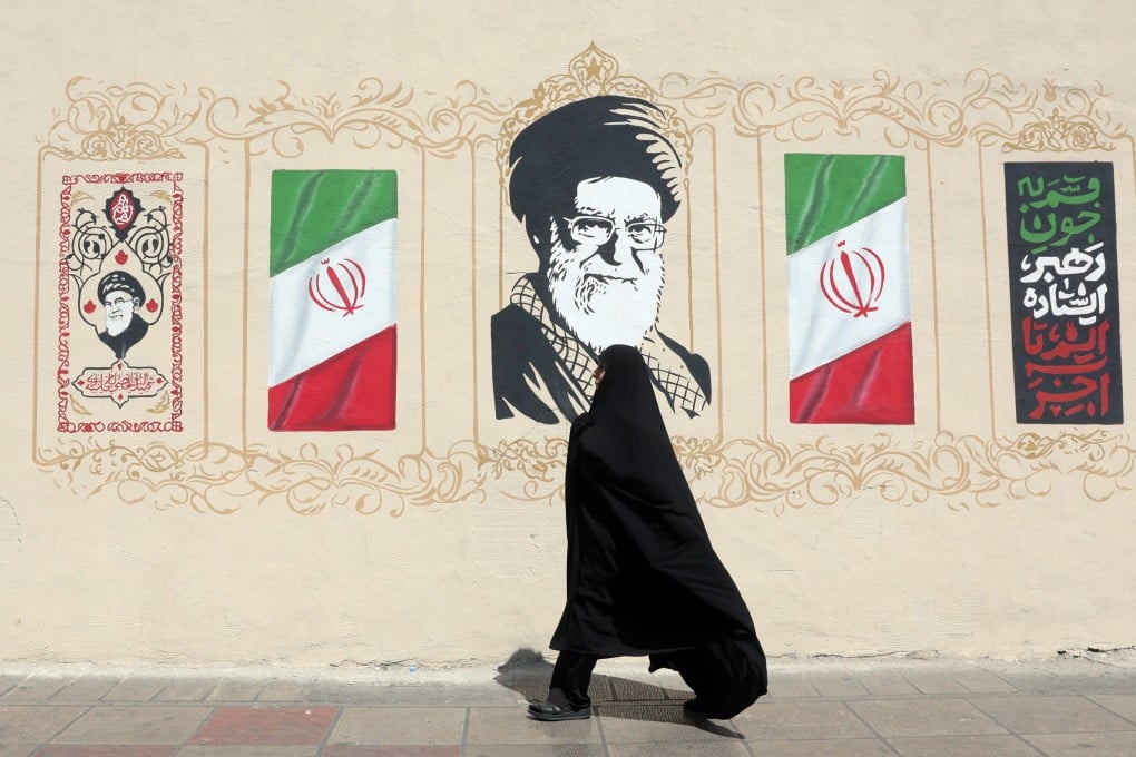 A woman walks next to a wall painting depicting the late Iranian supreme leader Ayatollah Ali Khamenei in Tehran, Iran, on Wednesday. Photo: EPA
