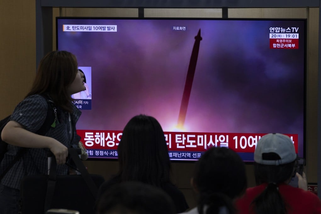 Passengers at a station in Seoul watch a news report about North Korea’s latest missile launches. Photo: EPA