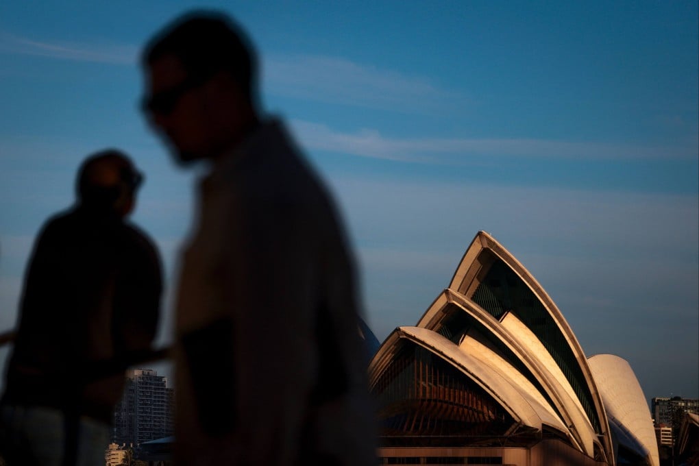 Tourists are seen in front of Australia’s Sydney Opera House in July. Photo: AFP