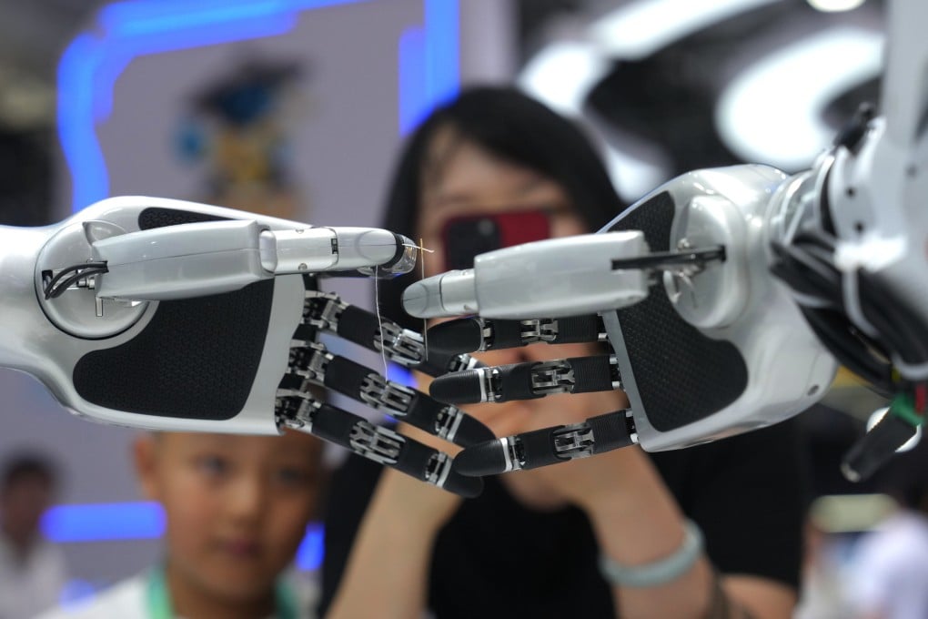Onlookers watch a robot thread a string through a needle during the World Robot Conference in Beijing on Wednesday. Photo: AP