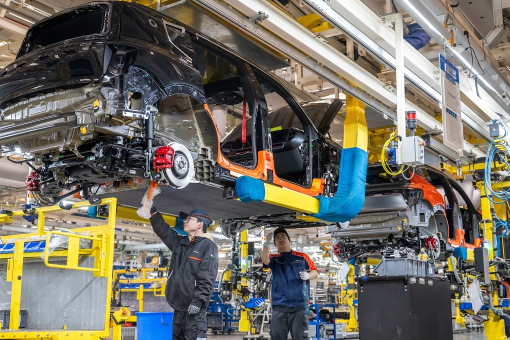 Technicians work at a Geely Auto plant in Zhejiang province. Photo: Getty Images