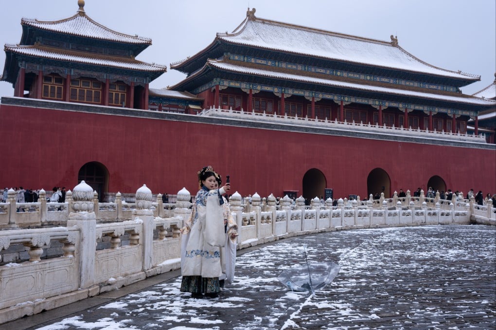 Women dressed in traditional costumes brave sub-zero temperatures during a visit to Beijing’s Forbidden City on March 5. Photo: Robert Ng