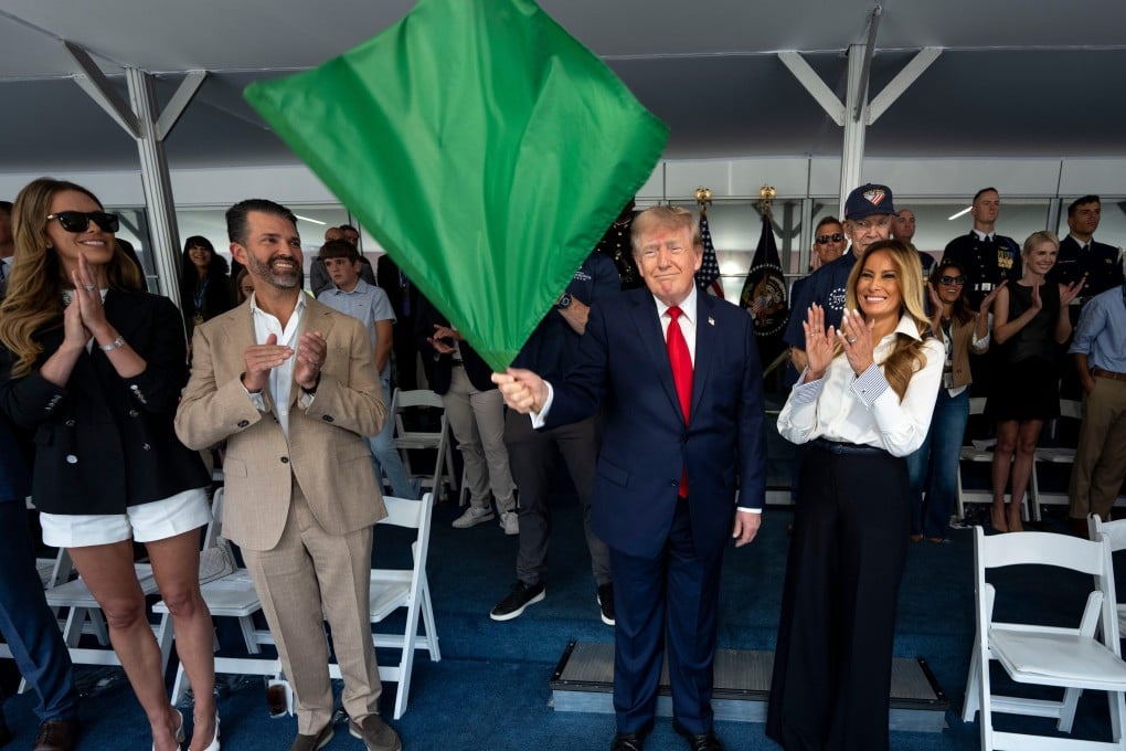 US President Donald Trump waves the green flag to start the race alongside First Lady Melania Trump, right, and from left, Bettina Trump and Donald Trump Jnr during the IndyCar Freedom 250 Grand Prix on Sunday in Washington. Photo: The New York Times via AP / Pool
