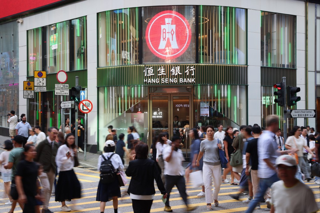 Pedestrians walk past a Hang Seng Bank branch in the Central district of Hong Kong. Photo: Jelly Tse