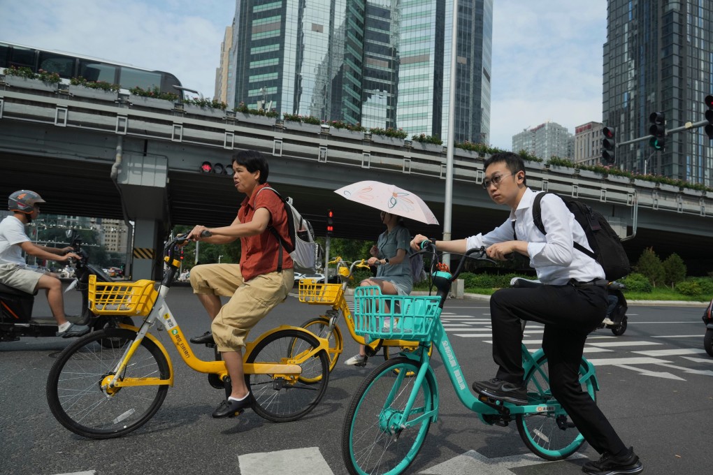 People ride bicycles on a street in Beijing. China’s leadership is looking to avoid an overreliance on strong policy stimulus while striving to reach economic growth goals. Photo: AP