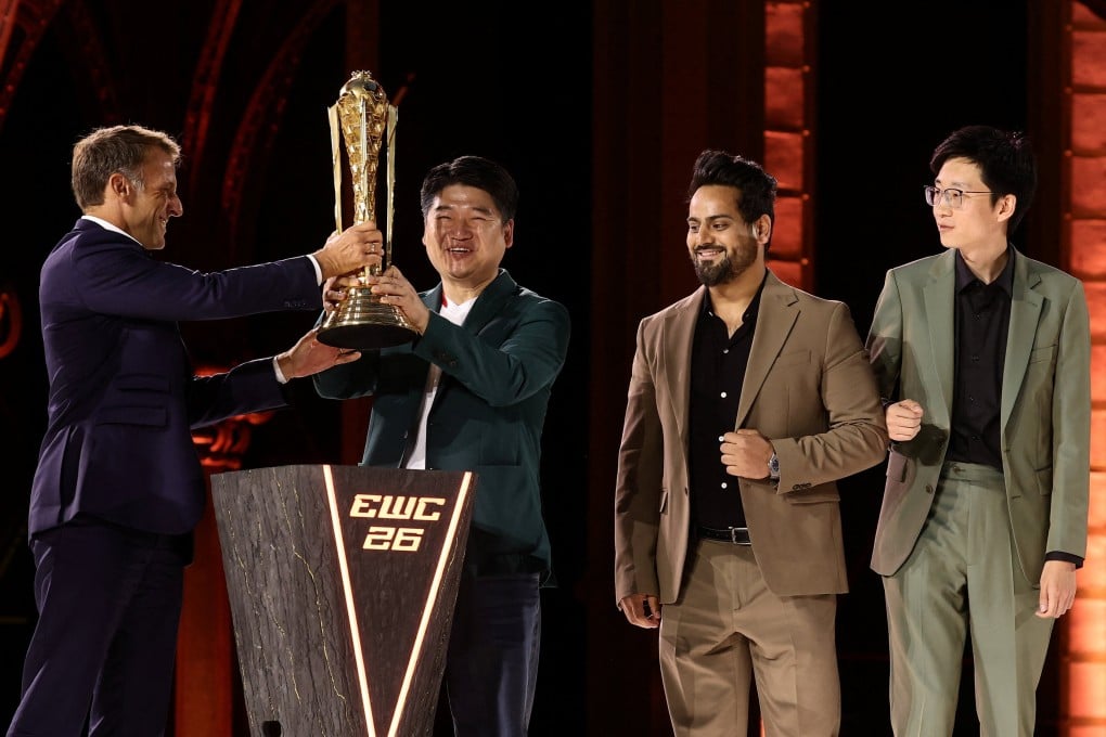French President Emmanuel Macron presents the EWC 2026 Club champions award to Chinese club AG.AL at the closing ceremony of the Esports World Cup at the Grand Palais in Paris on Sunday. Photo: Reuters