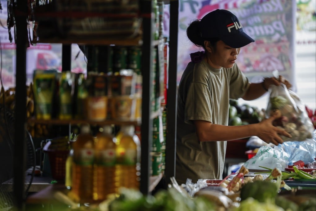 A vendor bags vegetables at a market in Quezon City, Metro Manila, Philippines, in August. Photo: EPA