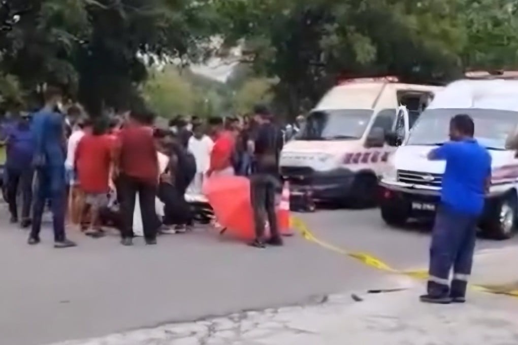 Paramedics attend to the victim after a brawl in Shah Alam, Malaysia’s Selangor state, on Tuesday in this still from a social media video. Photo: Threads