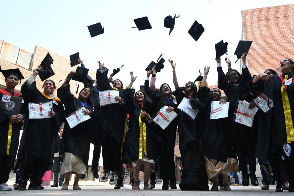 Students throw their graduation hats in the air at a university in Amritsar, India, in 2022. Photo: Nanu/AFP