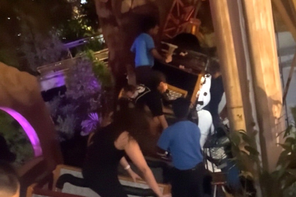 Theme park staff help stranded roller-coaster riders in this still from a social media video. Photo: Threads/wnelliesya