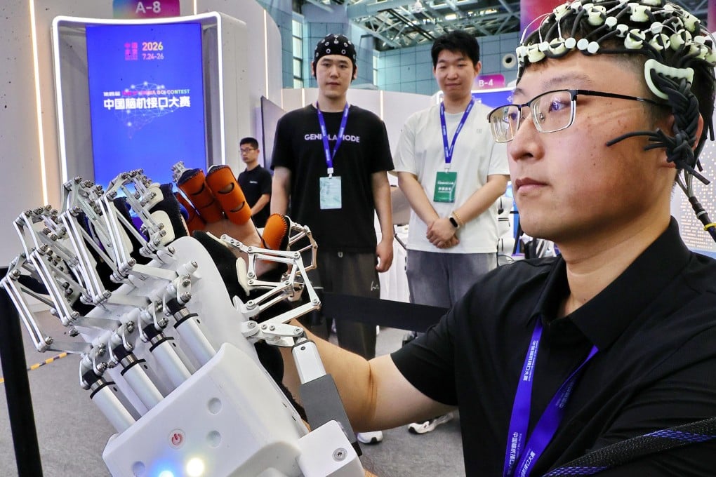 A member of Yanshan University’s team demonstrates a brain-controlled wearable robotic hand at the China Brain-Computer Interface Contest in Beijing last month. Photo: VCG via Getty Images