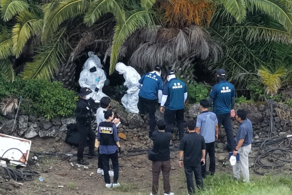 Investigators examine the scene at a palm tree farm in Jeju where the body of missing woman Jang Mi-ran was found on Monday. Photo: Yonhap/EPA