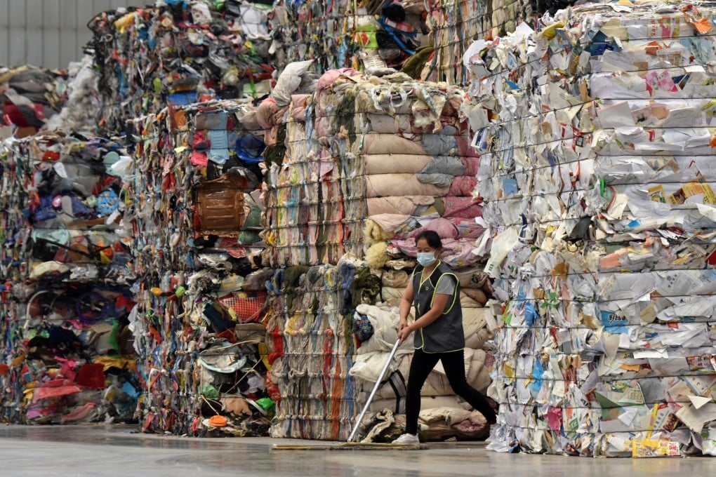 A worker mops the floor at a waste-sorting centre in Taiyuan, Shanxi province. Photo: VCG via Getty Images