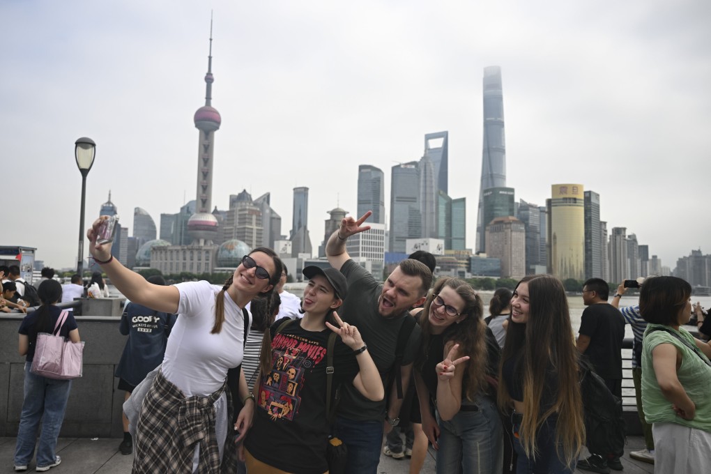 Tourists from Russia take a selfie at the Bund area in Shanghai. Photo: Xinhua