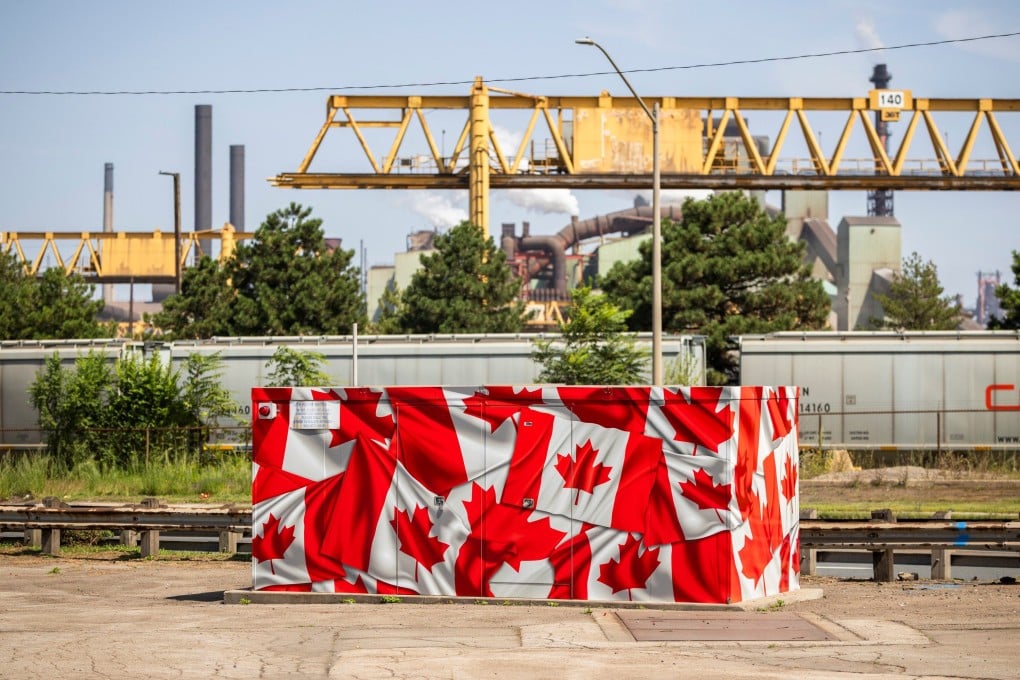 A utilities box covered in Canadian flags sits in front of a steel plant in Hamilton, Ontario, Canada, on August 20. Although Canada’s economy will bear the brunt of a full-blown trade war, the US will suffer, too. Photo: The Canadian Press via AP