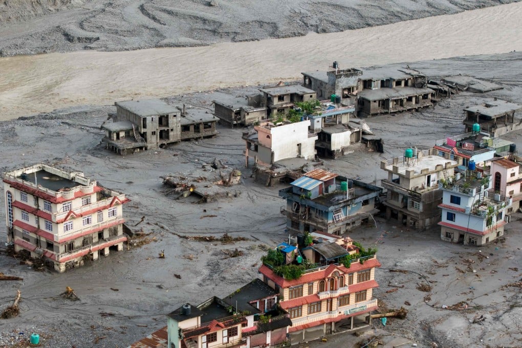 An aerial view shows houses lying deluged in sludge after flash floods at Devighat in Nepal’s Nuwakot district on August 27. Photo: AFP