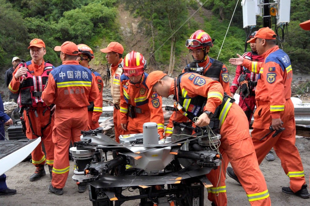 Firefighters assemble near a drone during rescue operations in Gyirong county in the Tibet autonomous region near the border with Nepal. Photo: Reuters