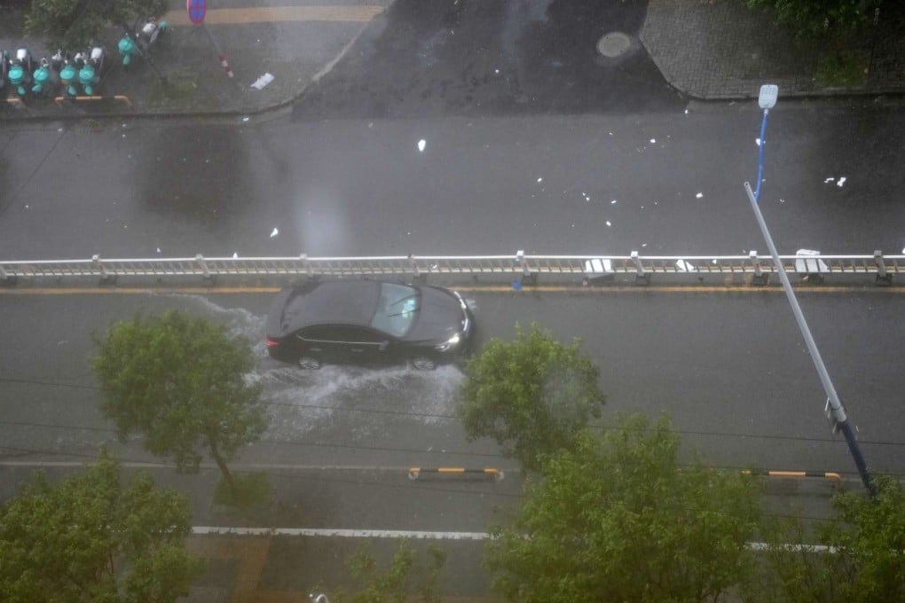 On Friday, a car travels through water in Longwan District of Wenzhou City, in Zhejiang province. Typhoon Saudel made landfall in Zhejiang, with up to Force 12 winds, according to the provincial weather observatory. Photo: Xinhua