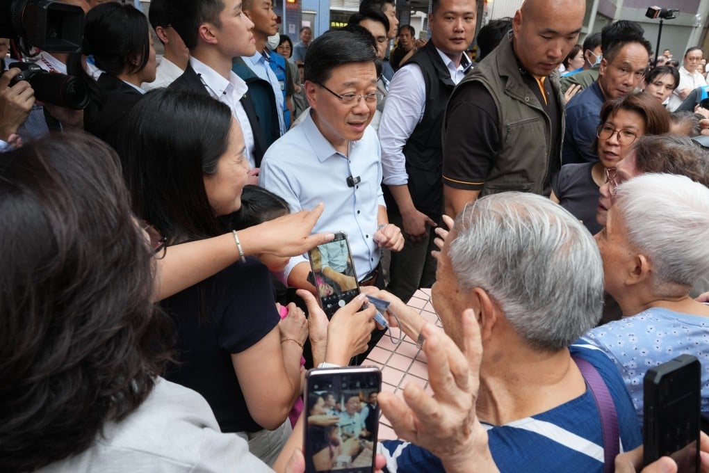 Hong Kong Chief Executive John Lee Ka-chiu greets local residents during a visit to a housing estate in Cheung Sha Wan on August 26. Photo: Karma Lo