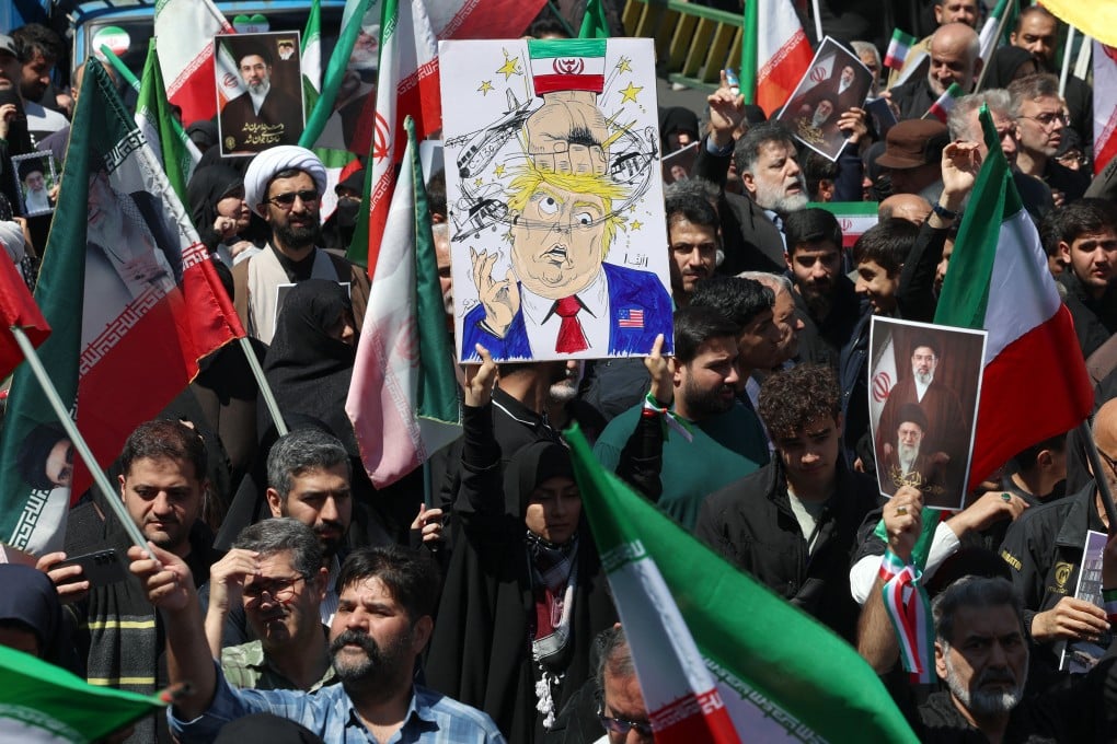 A woman holds up a poster mocking US President Donald Trump while others carry portraits of Iran’s slain supreme leader Ayatollah Ali Khamenei and his son, Mojtaba Khamenei, during a rally in Tehran on April 9. Photo: AFP